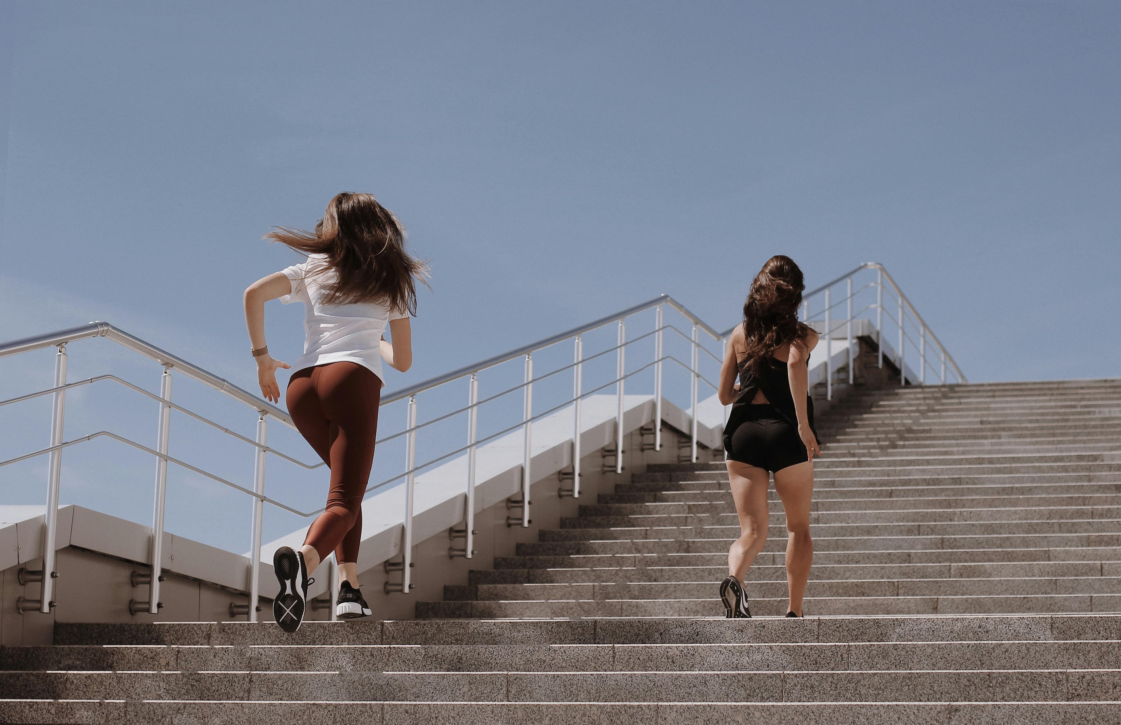 Athletes charging stairs together